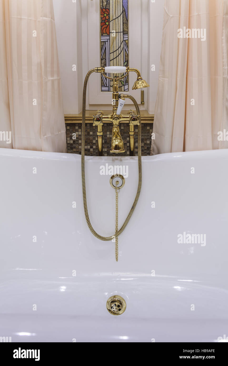 gold bathtub faucets and shower head Stock Photo Alamy