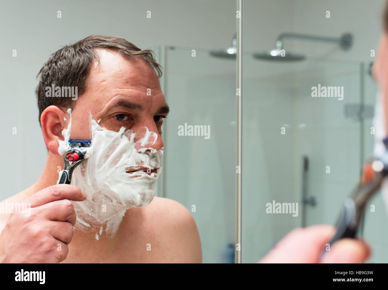 Man shaves the face Stock Photo