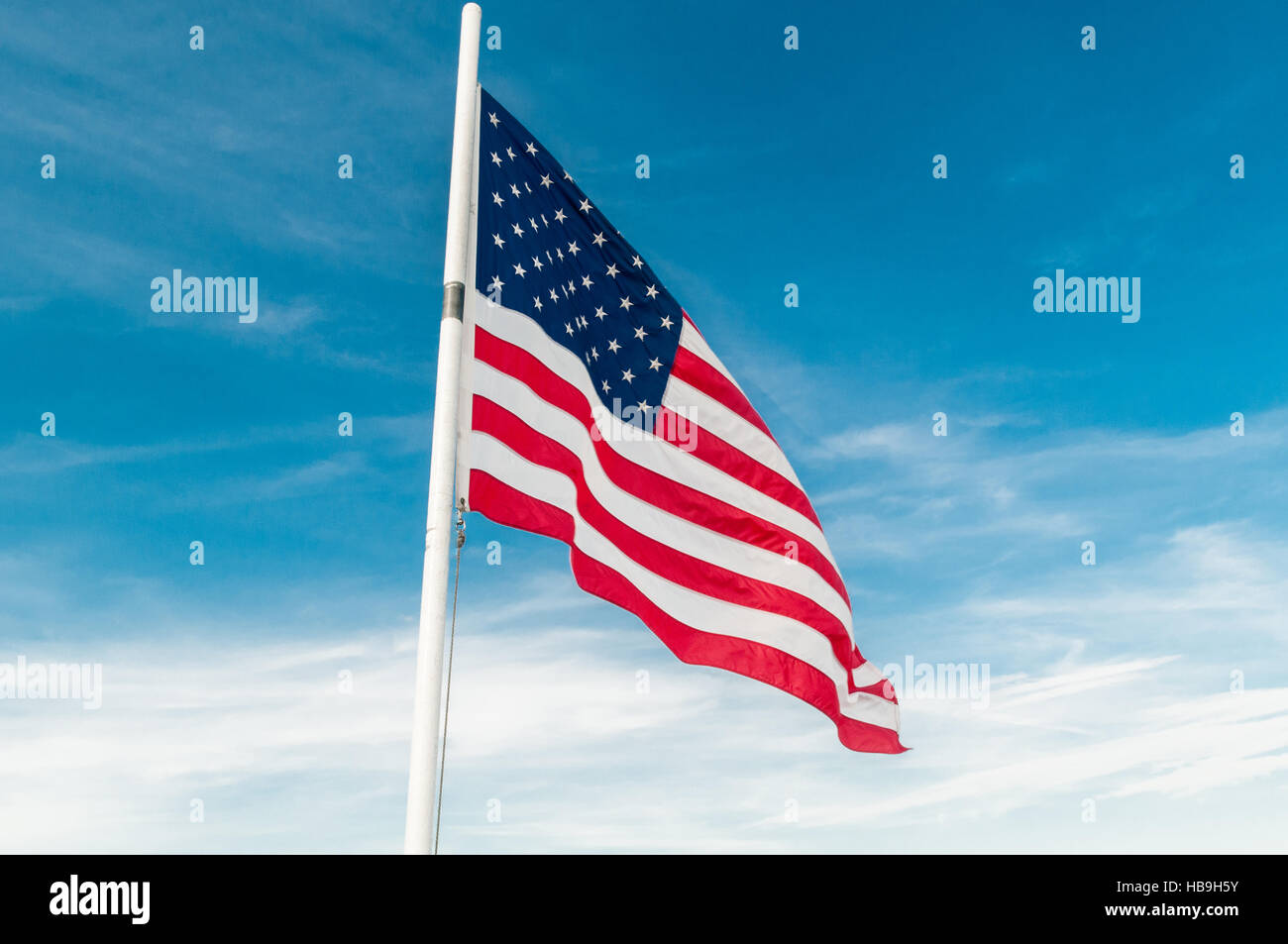 American flag against bright blue sky Stock Photo - Alamy