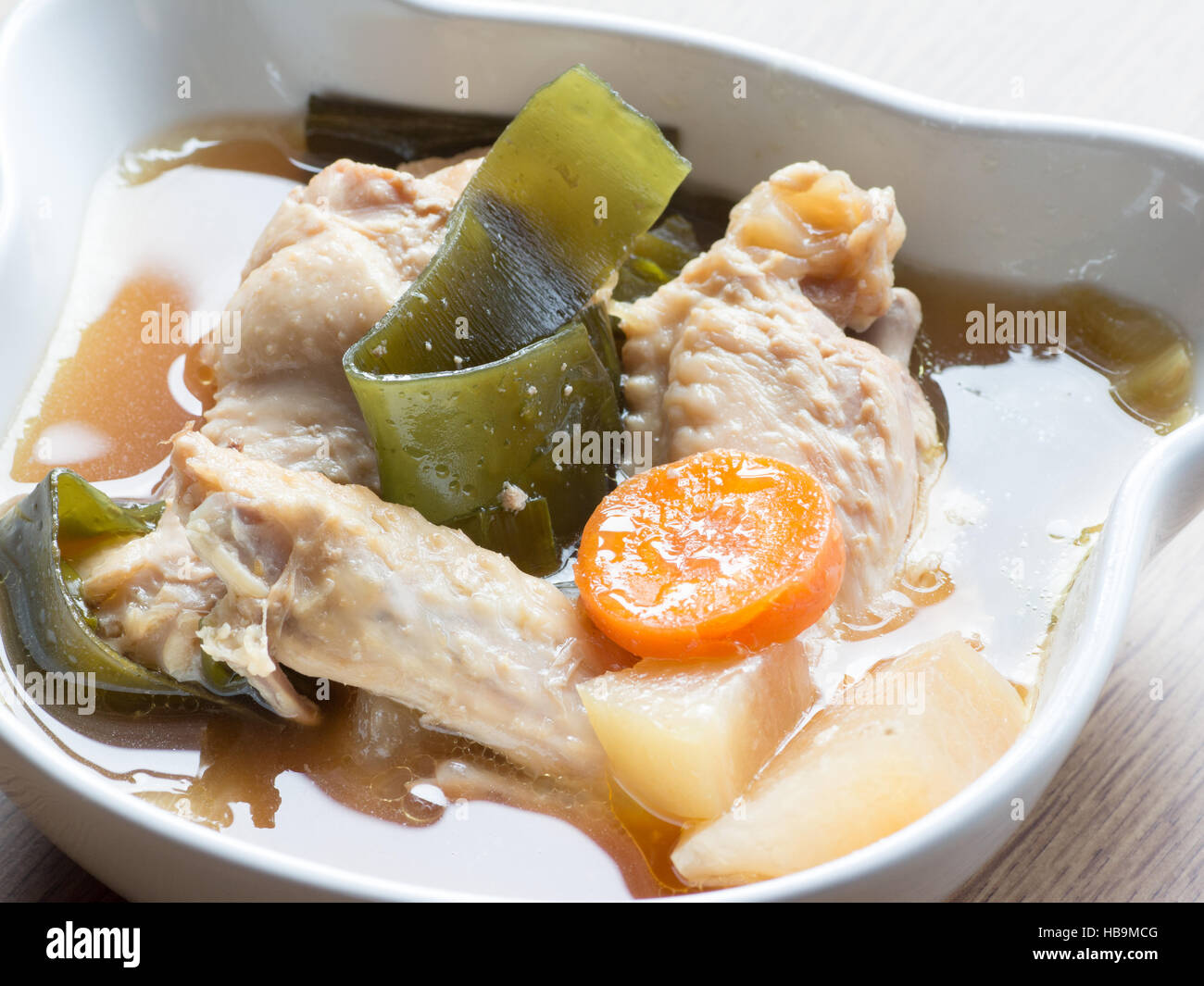 Japanese cuisine, chicken soup with daikon, carrot, and konbu Stock Photo