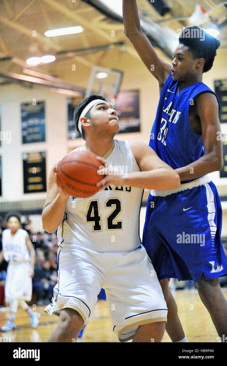 High school center posting up on a defender will seeking an opportunity to launch a shot from under the basket. USA. Stock Photo