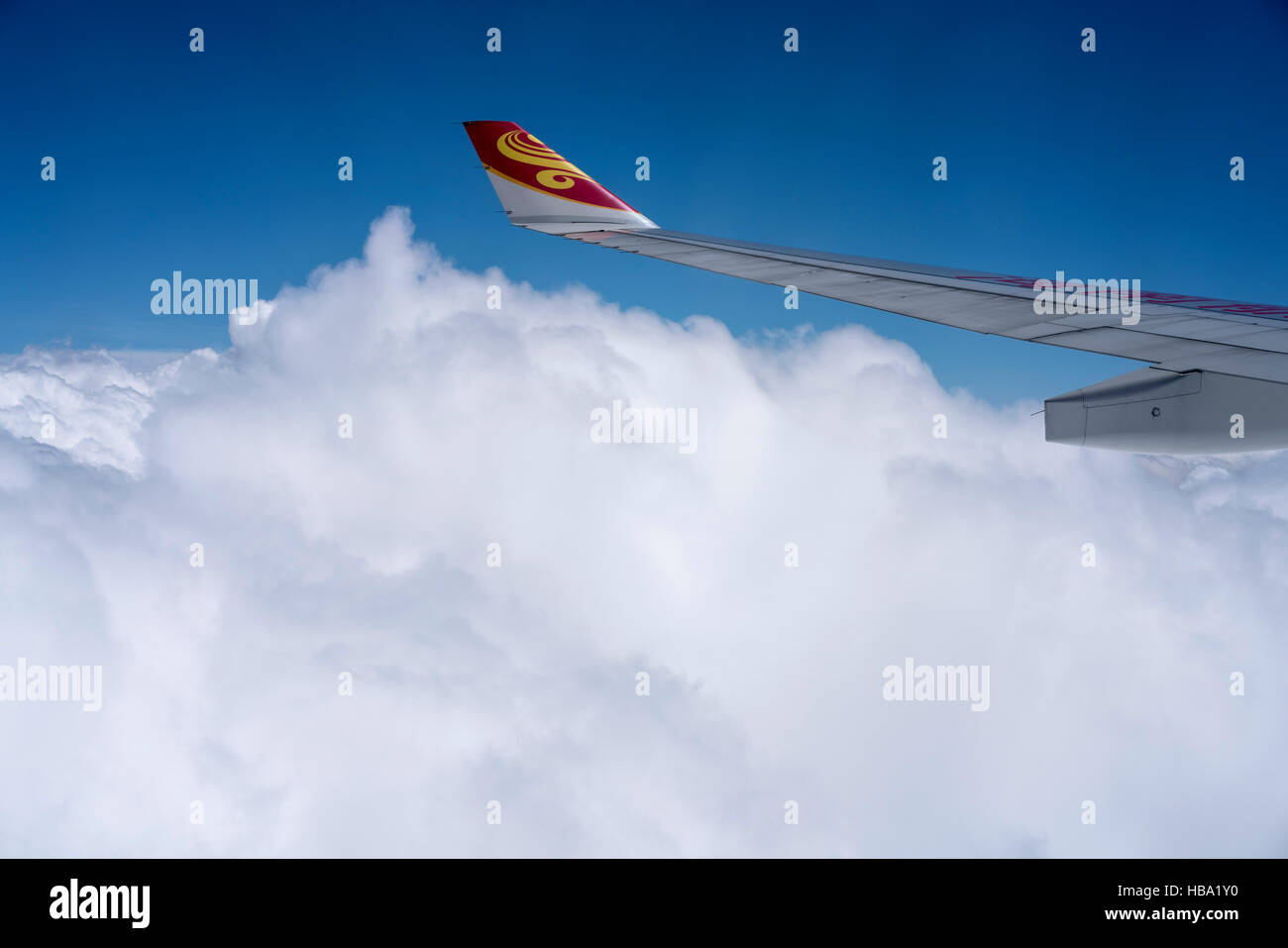 View of jet aircraft wing above the clouds Stock Photo