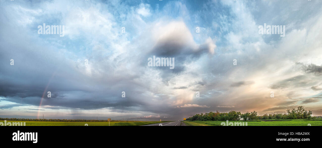 Multi-colored rainbow after the rain passed Stock Photo - Alamy