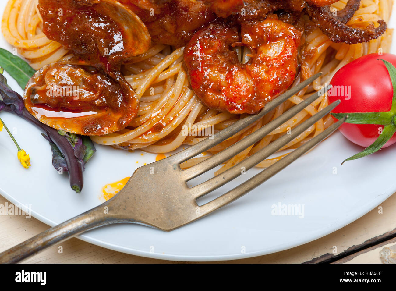 Italian seafood spaghetti pasta on red tomato sauce Stock Photo - Alamy