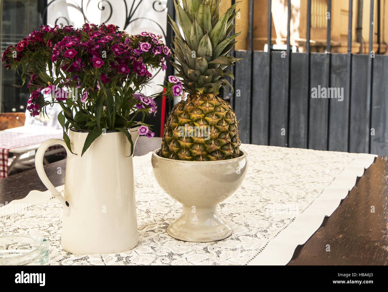 Flowers and pineapple on table Stock Photo