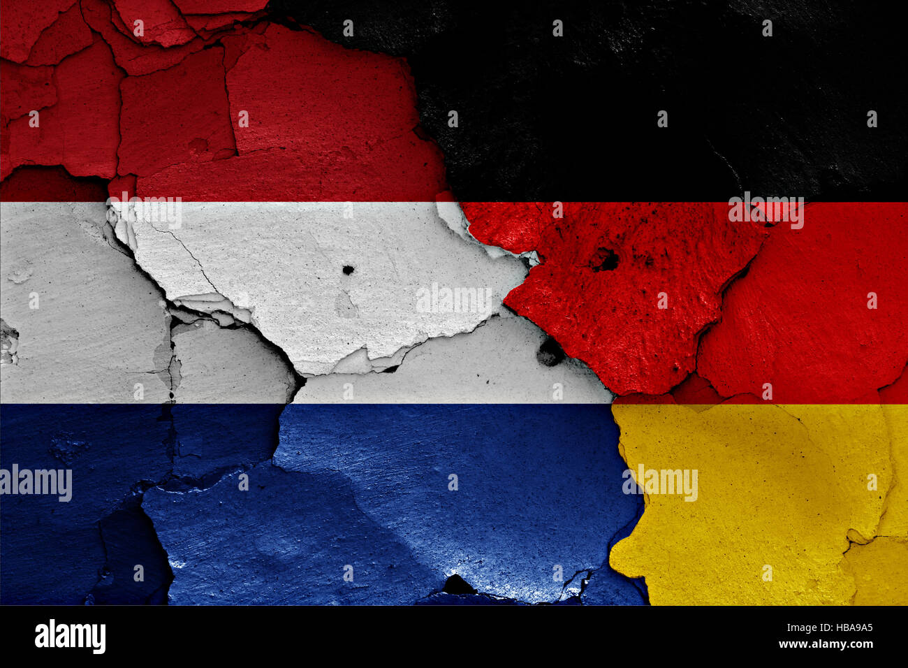 flags of Netherlands and Germany painted on cracked wall Stock Photo