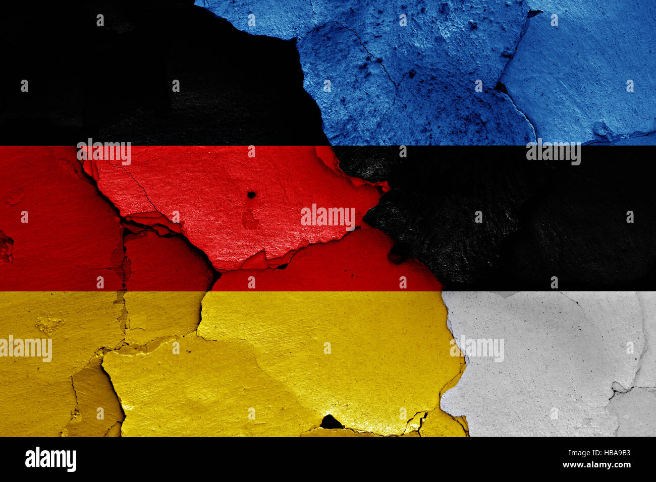 flags of Germany and Estonia painted on cracked wall Stock Photo