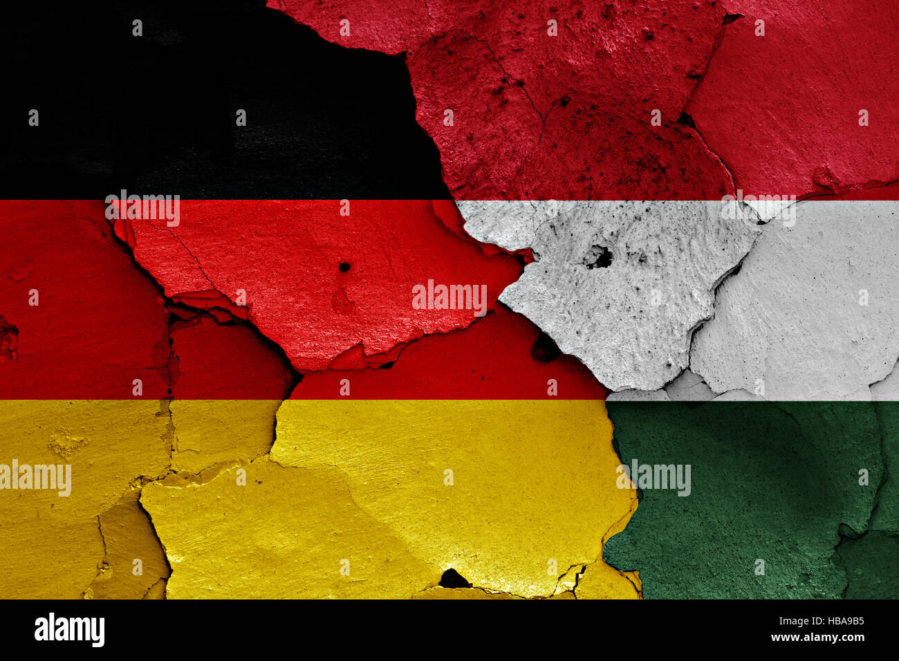 flags of Germany and Hungary painted on cracked wall Stock Photo