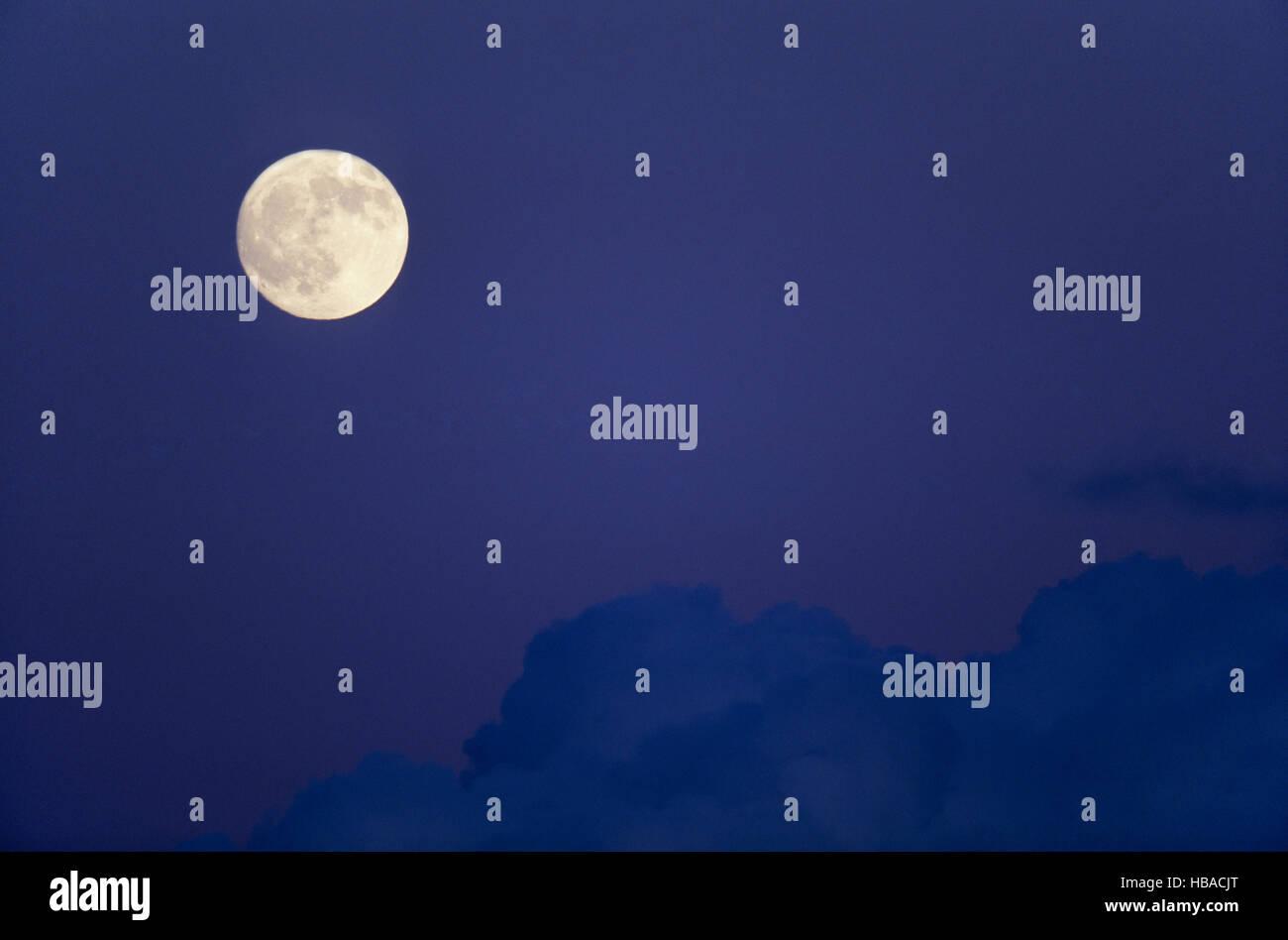 Full moon and clouds in the night sky Stock Photo