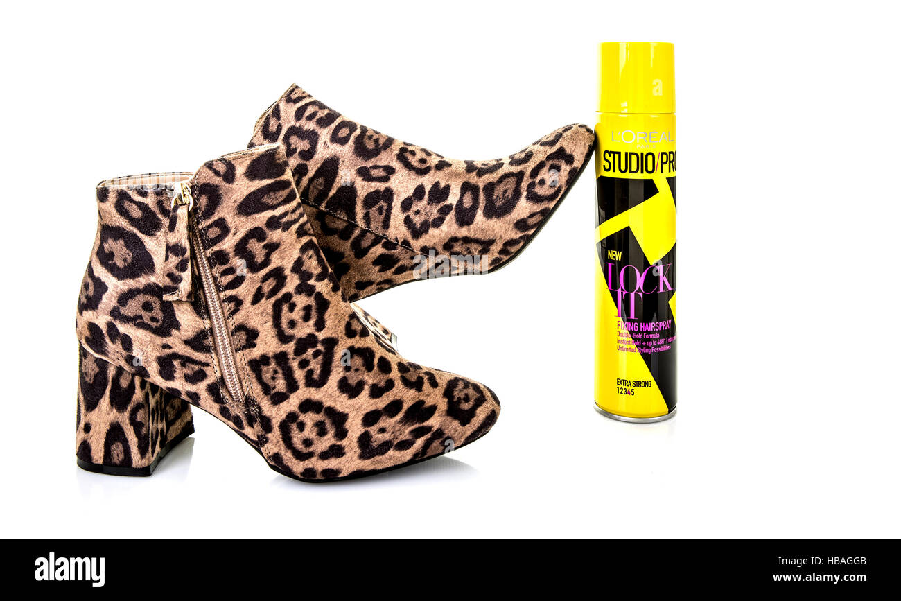 Pair of Leopard Skin Boots with a can of Loreal Studio Pro Lock It hair spray Stock Photo