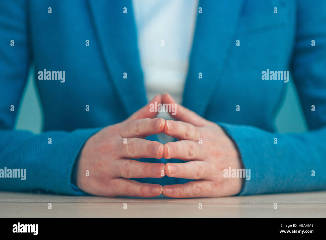 Steepled fingers of business woman as hand gesture sign of confidence, self-esteem, power and domination. Stock Photo