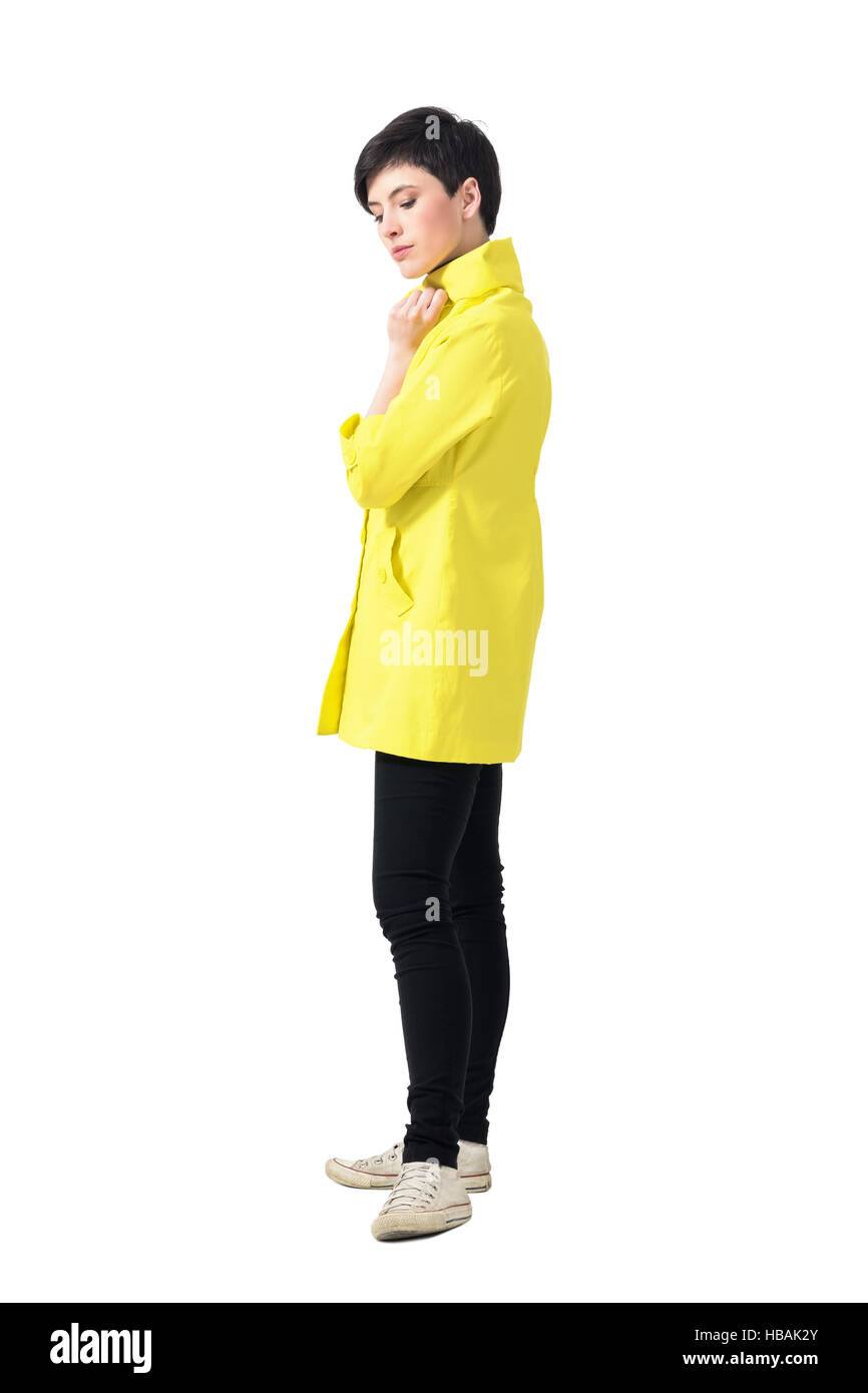 Gentle Feminine Young Short Hair Woman In Yellow Coat Looking Down