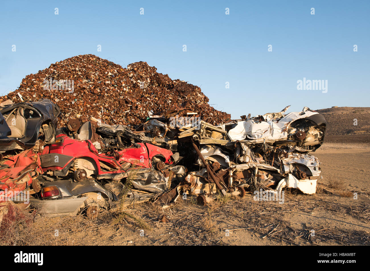 Pile  of various scrap cars and other metals on a field ready for the recycling industry. Stock Photo