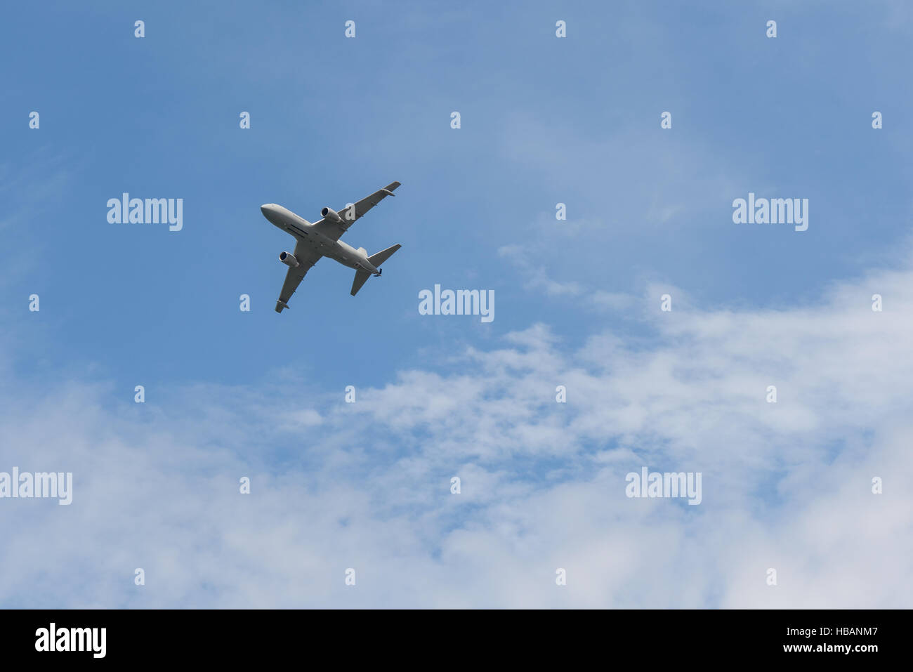 airplane jet flying in a blue sky Stock Photo