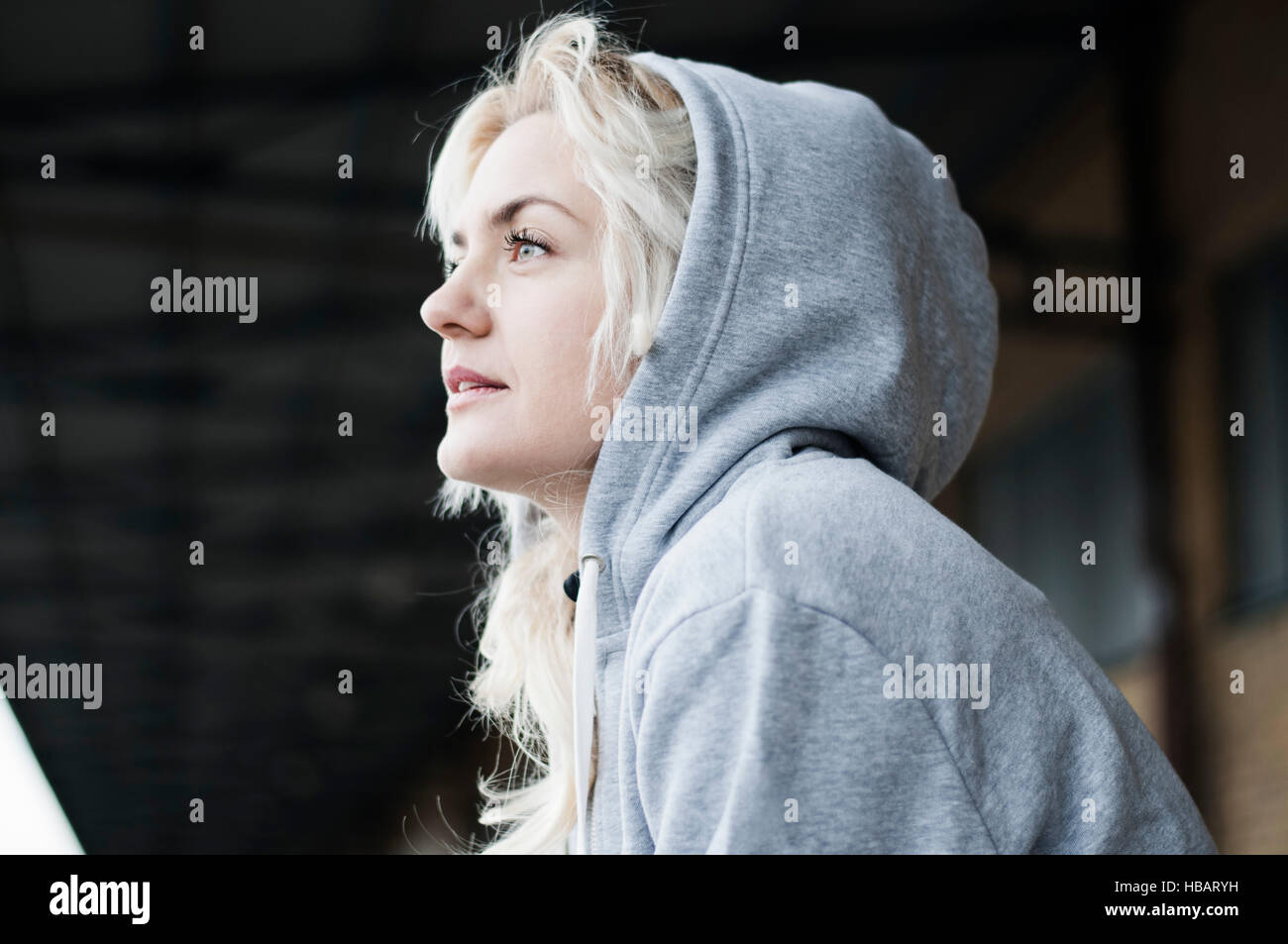 Portrait of mid adult female runner in grey hoody Stock Photo