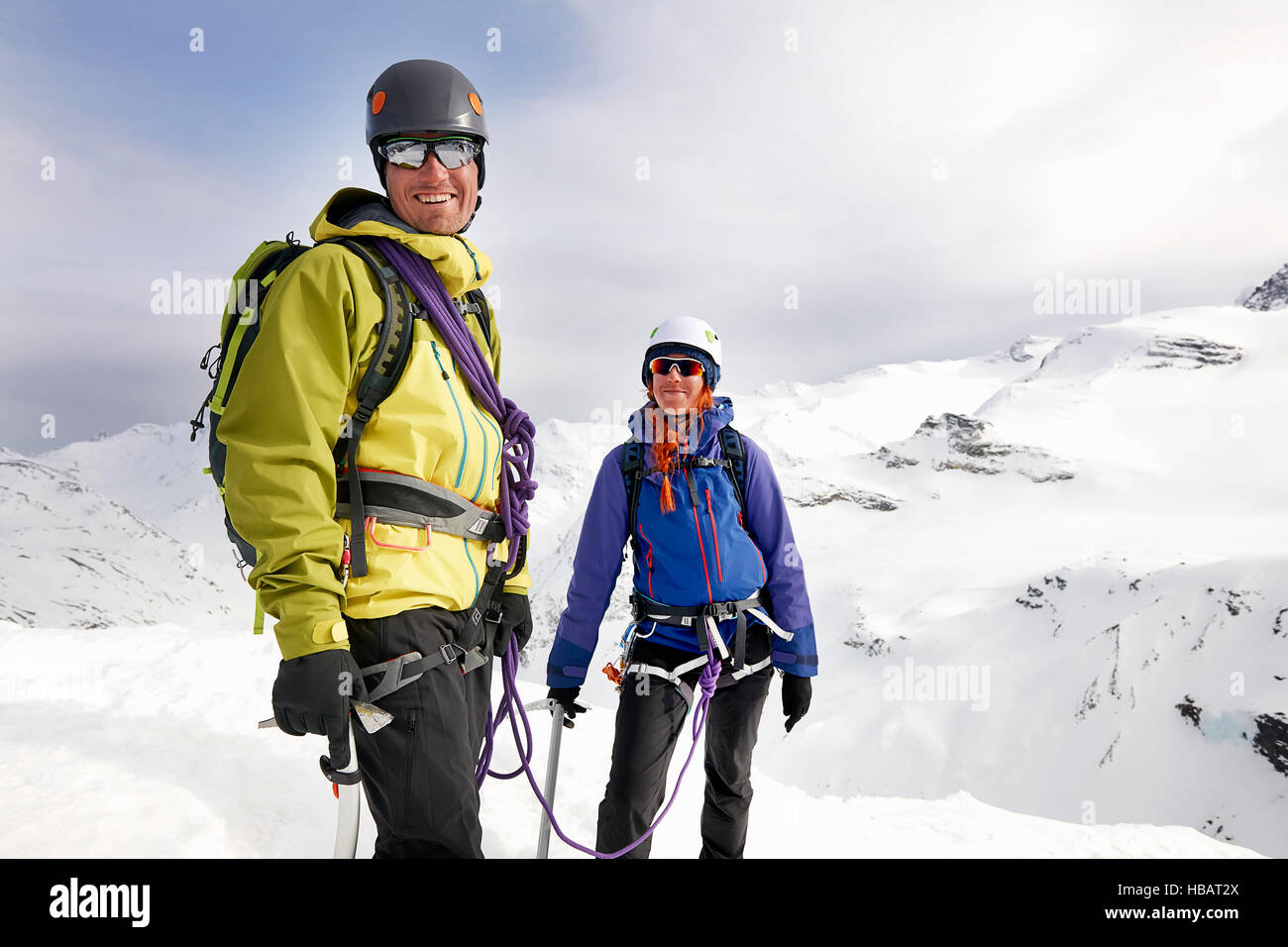 Mountaineers on snow-covered mountain looking at camera smiling, Saas Fee, Switzerland Stock Photo