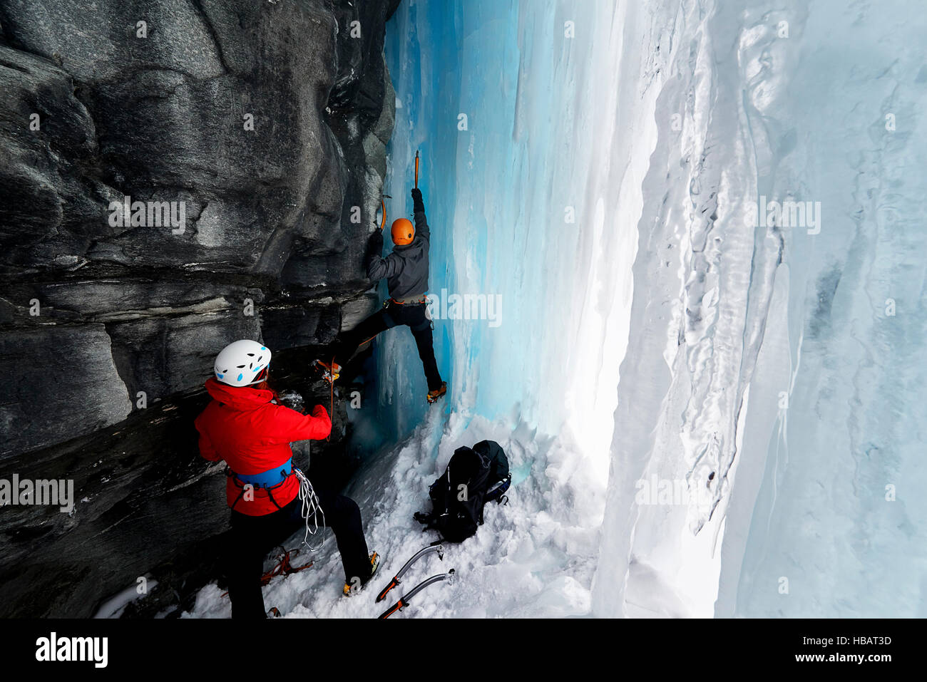 Couple in cave ice climbing, Saas Fee, Switzerland Stock Photo