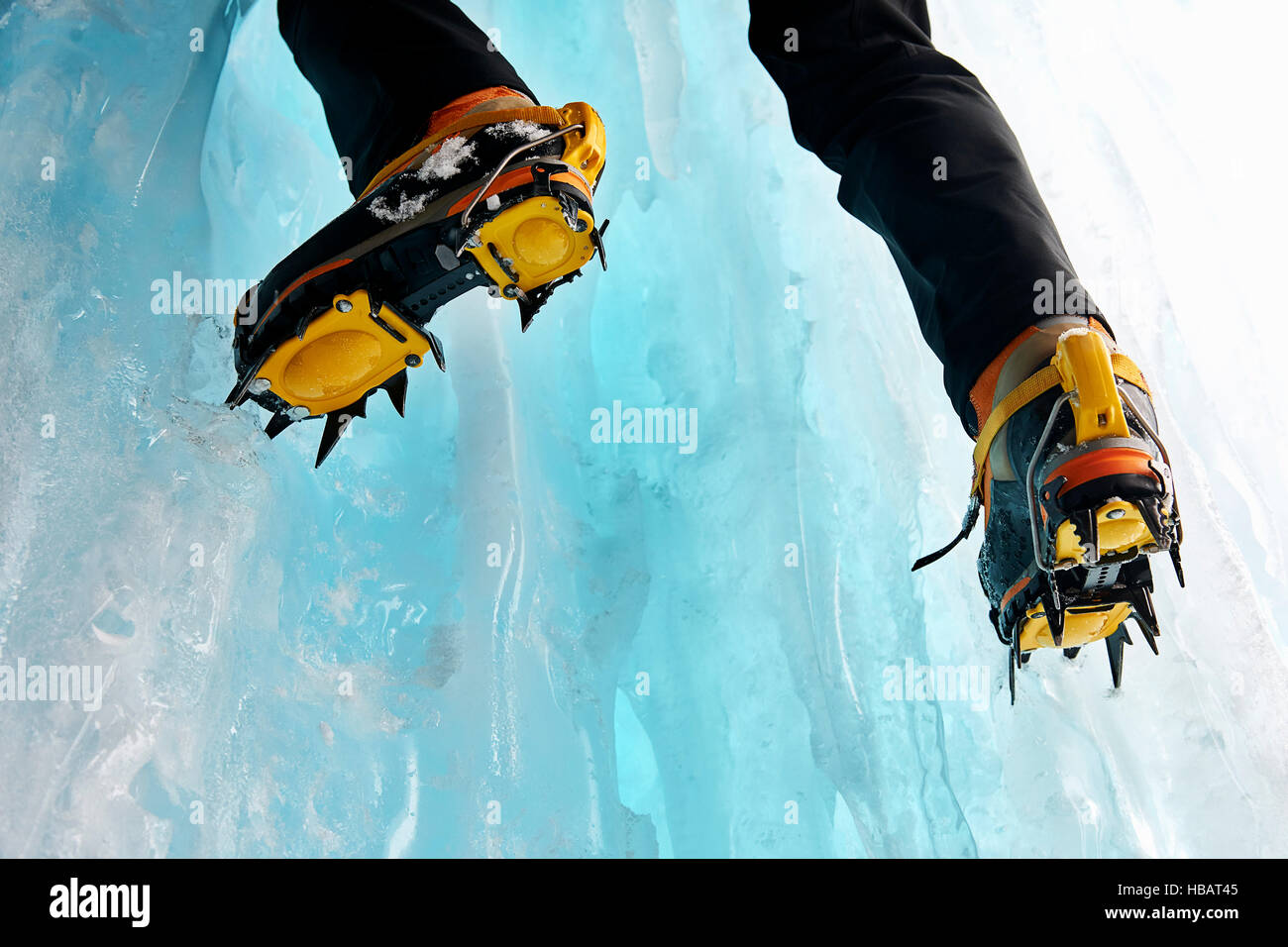 Cropped view of ice climbers feet wearing crampons Stock Photo