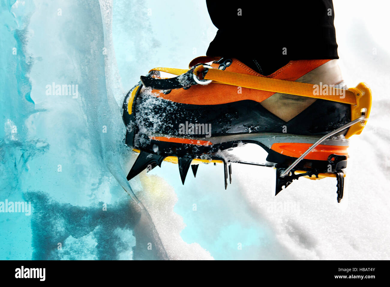 Cropped view of ice climbers feet wearing crampons Stock Photo