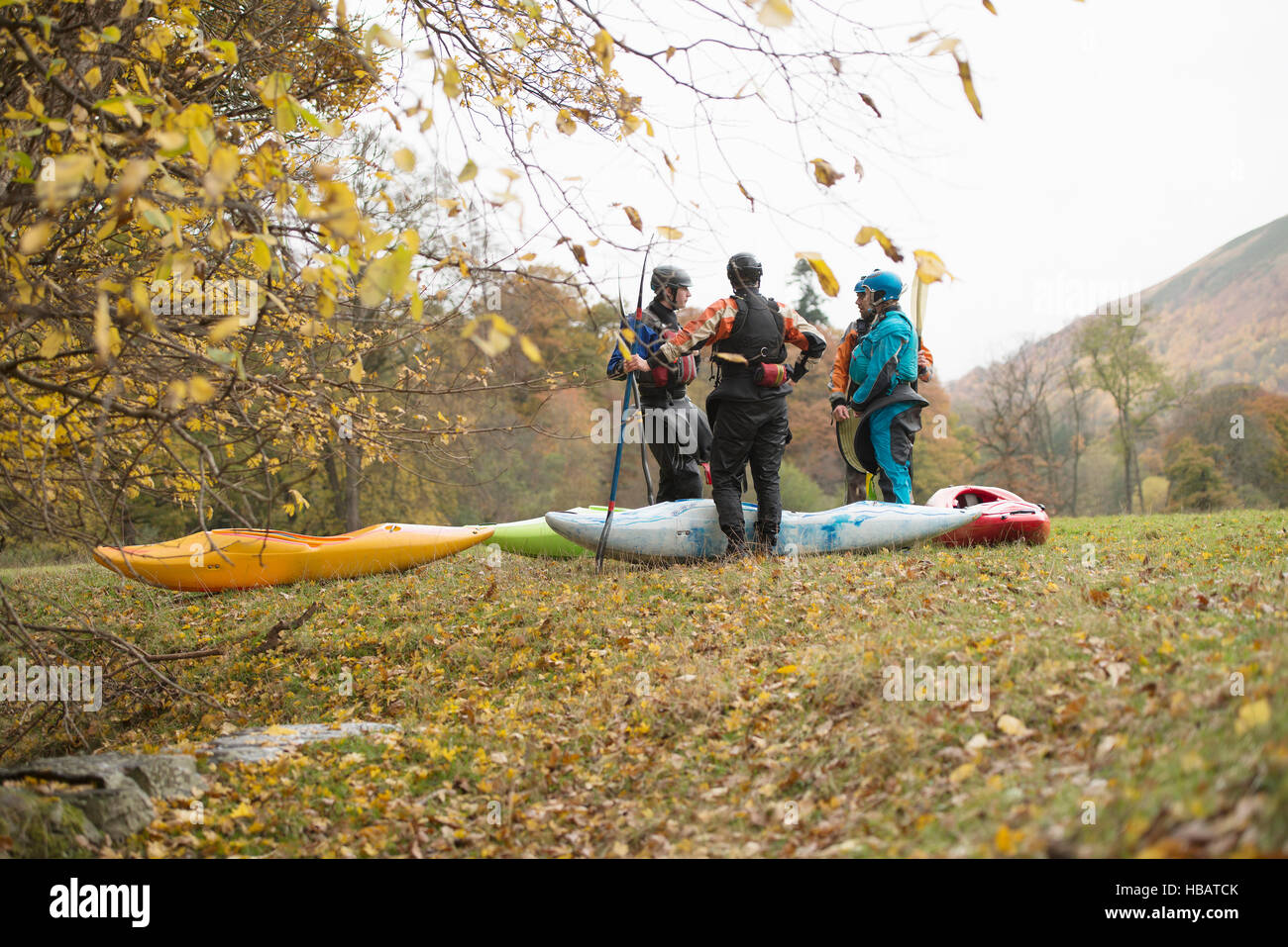 Male and female kayakers having team talk, Llangollen, North Wales Stock Photo