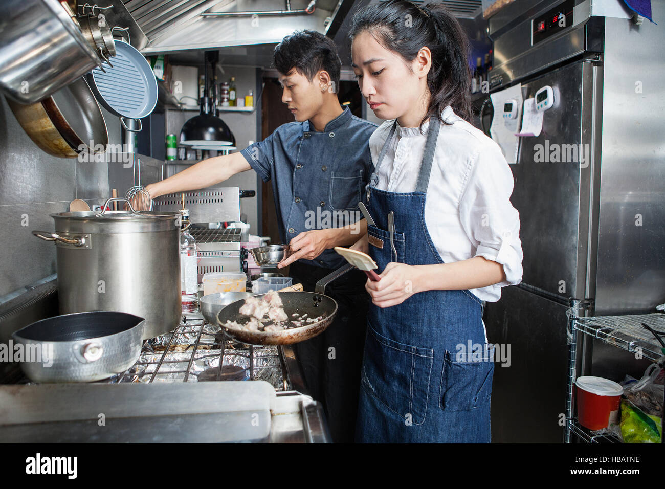 Chefs cooking in commercial kitchen Stock Photo Alamy