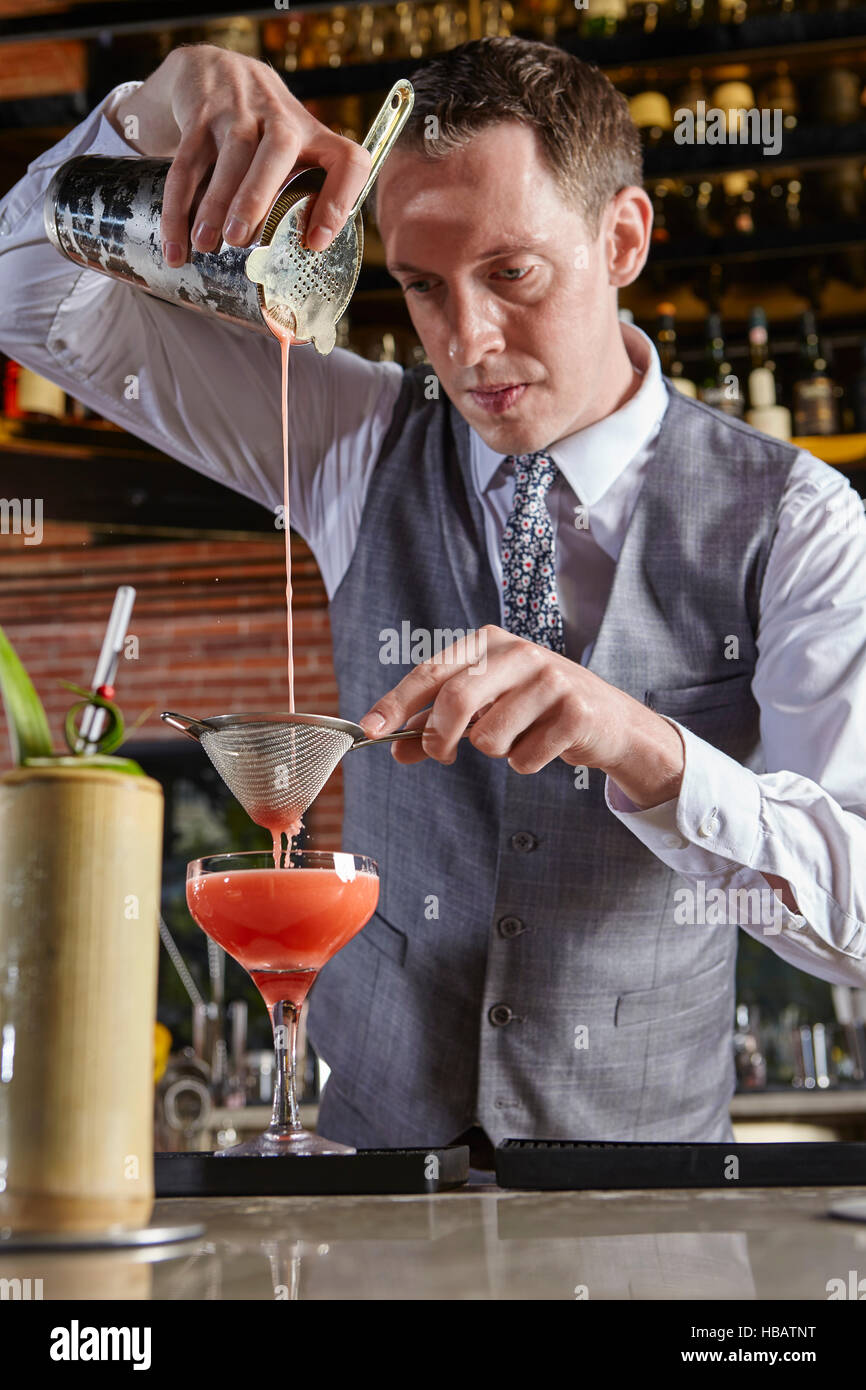 Bartender pouring cocktail Stock Photo