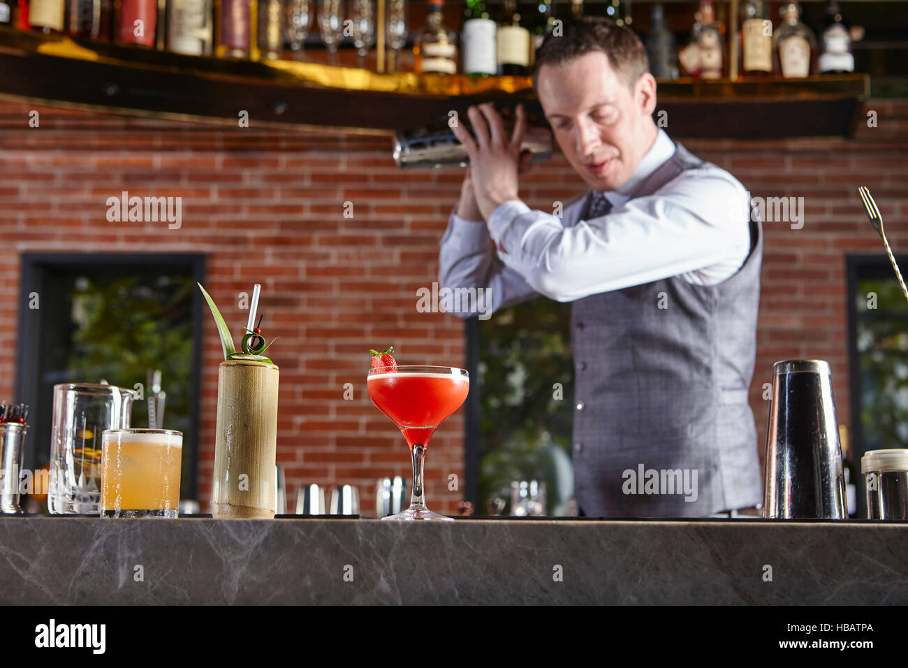 Bartender shaking cocktail shaker Stock Photo Alamy