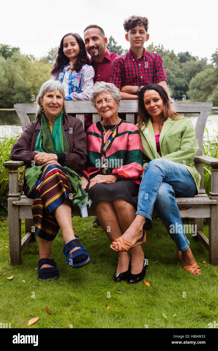 Portrait of four generation family, beside lake, smiling Stock Photo