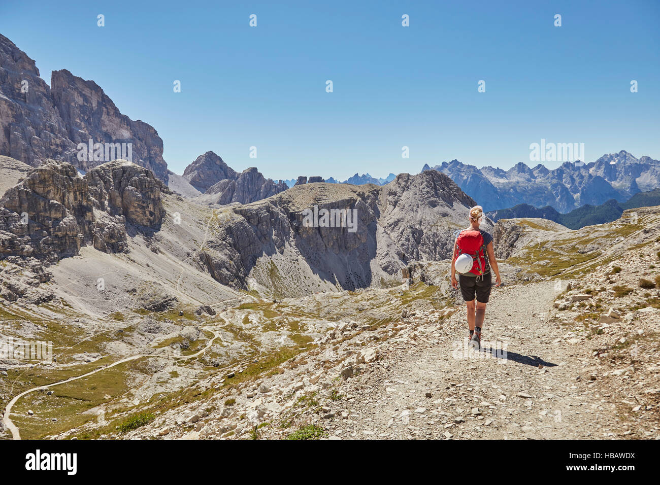 Rear view of female hiker hiking in Dolomites, Sexten, South Tyrol, Italy Stock Photo