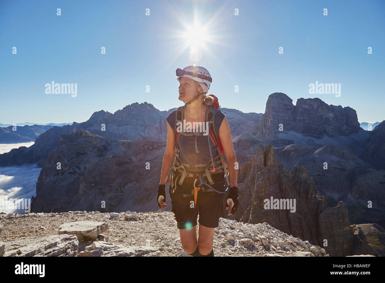 Female hiker arriving on Paternkofel mountain peak, Dolomites, Sexten, South Tyrol, Italy Stock Photo
