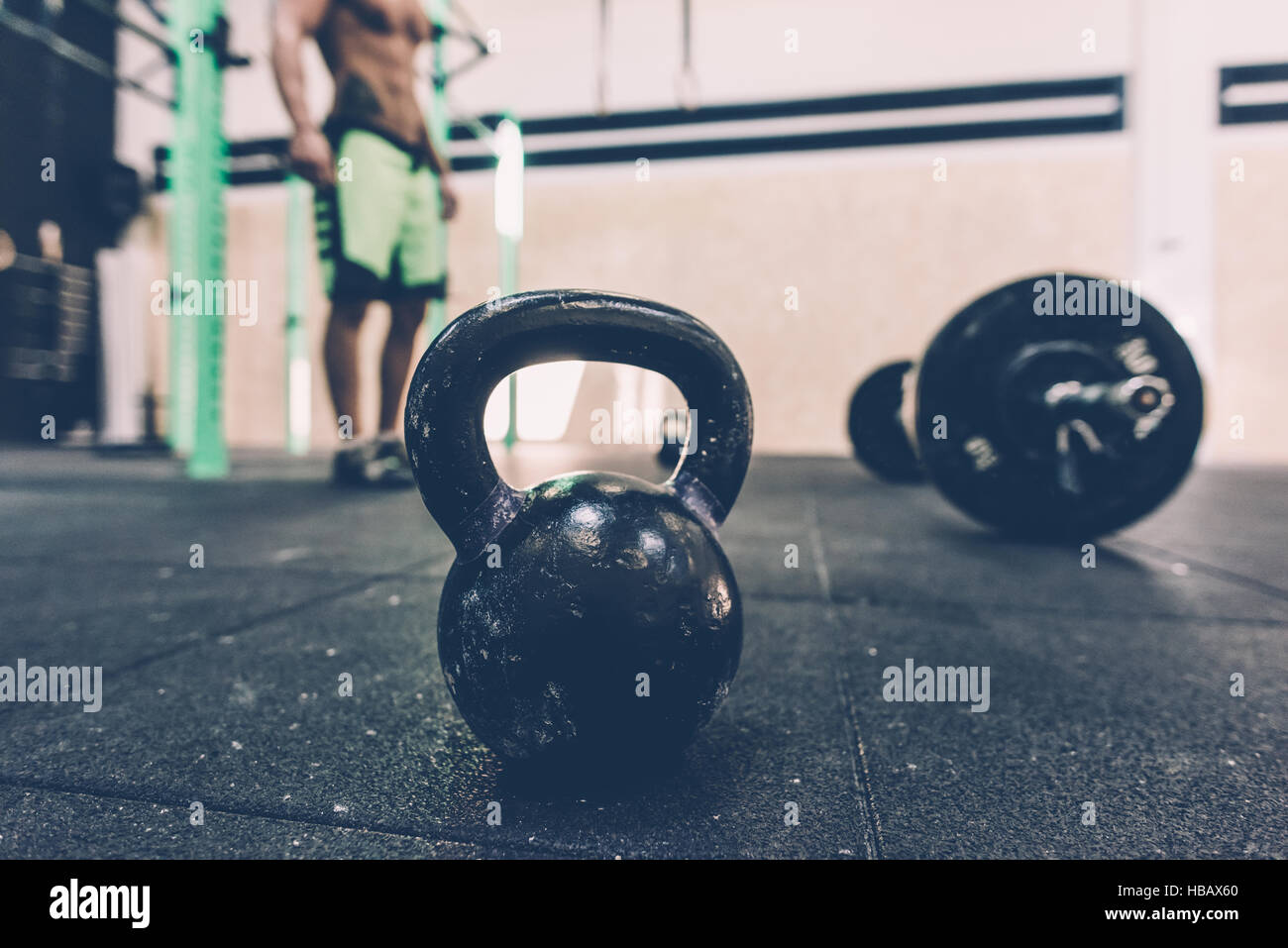Kettlebell and barbell on floor of cross training gym Stock Photo