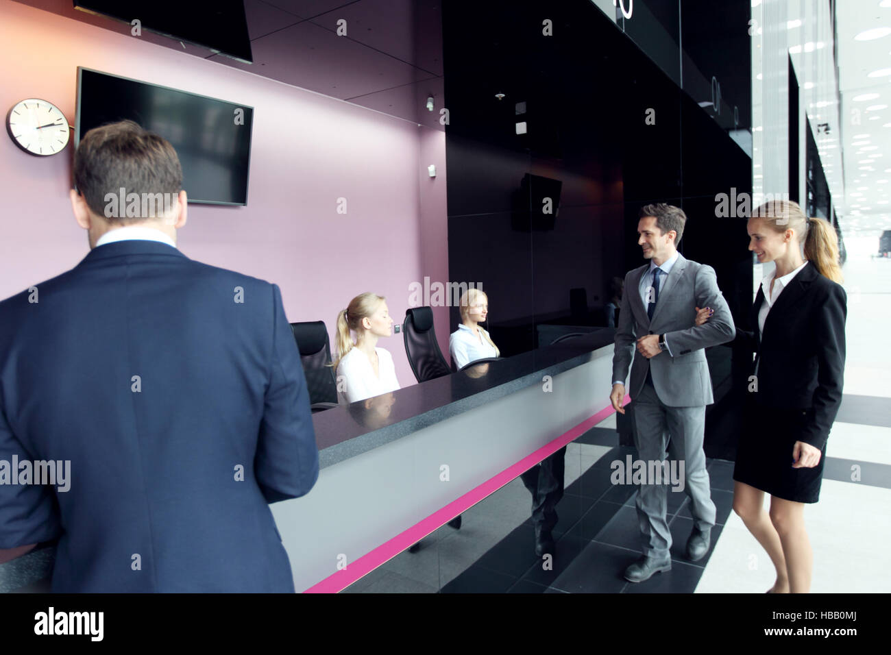 Business people at front desk of airport or modern office building Stock Photo