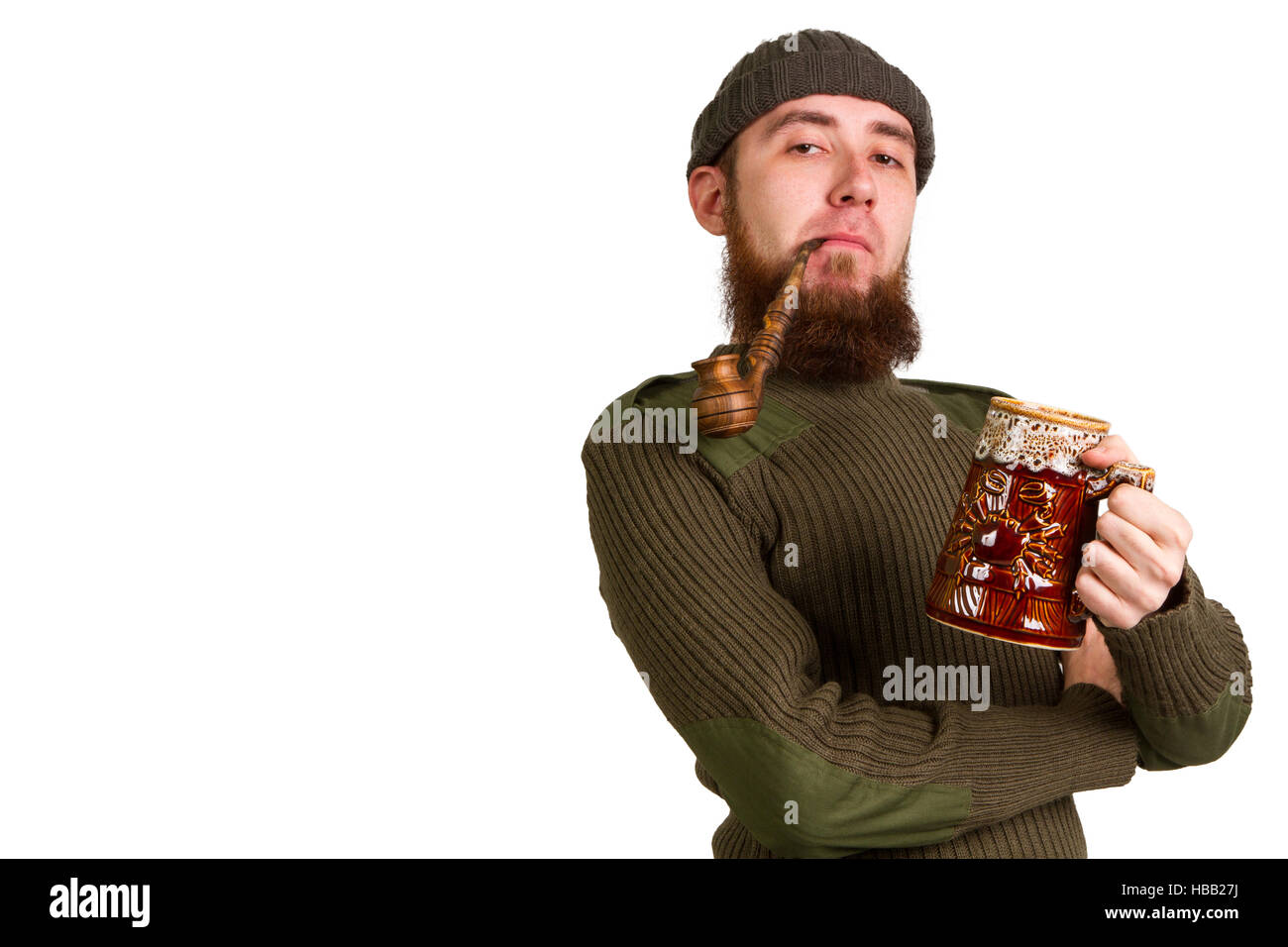 young bearded guy smoking a pipe Stock Photo