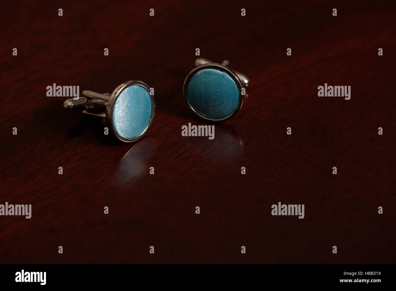 Cuff links and tie on mahogany wooden background Stock Photo