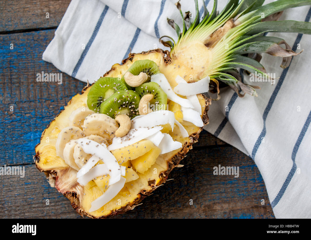 cut in half pineapple with coconut chia kiwi cashew perfect for