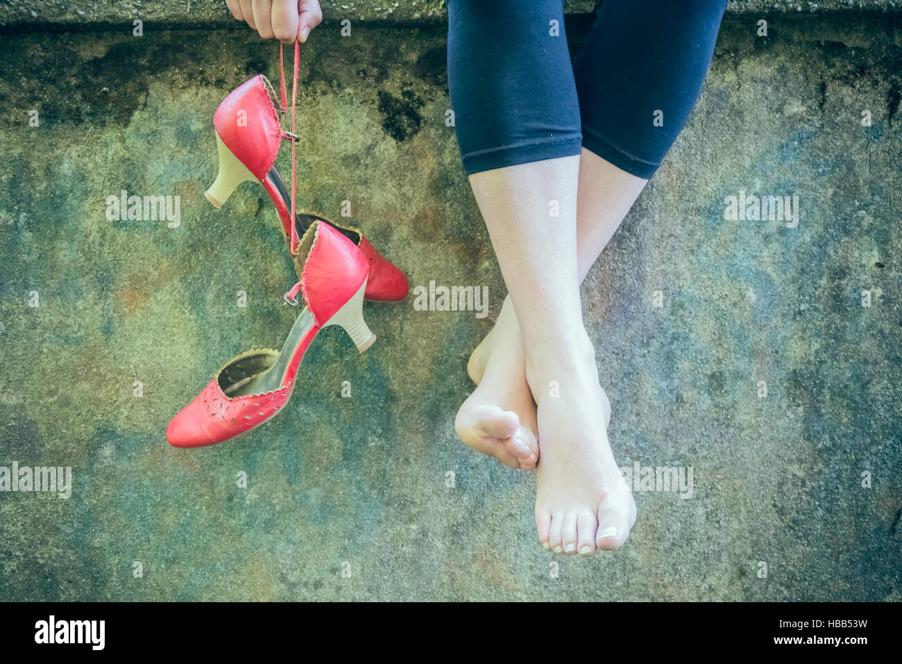 Woman legs on a wall Stock Photo