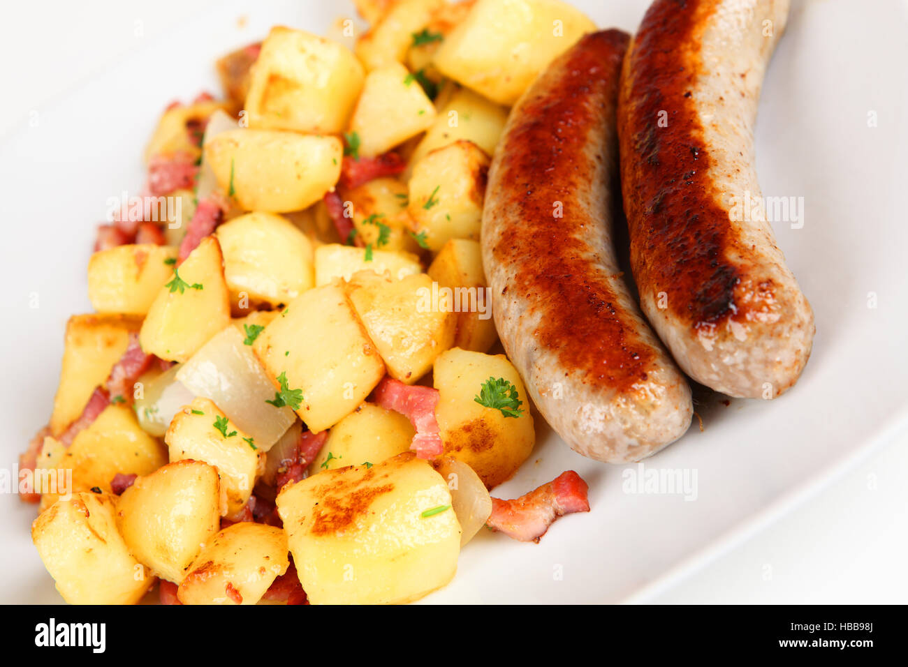 sausage and fried potatoes Stock Photo Alamy