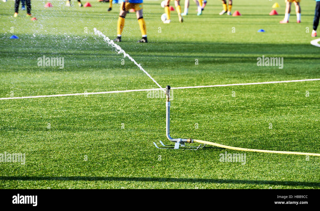 Watering the 3G artificial astro turf pitch at Sutton United Football Club Stock Photo