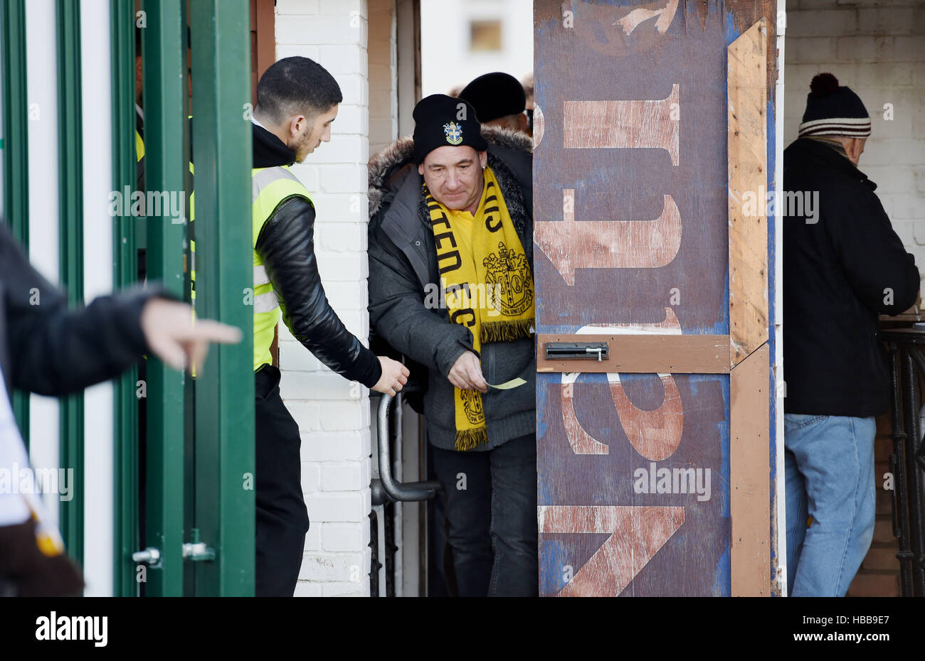 Fans come through the turnstiles for a Sutton United Football Club match Stock Photo