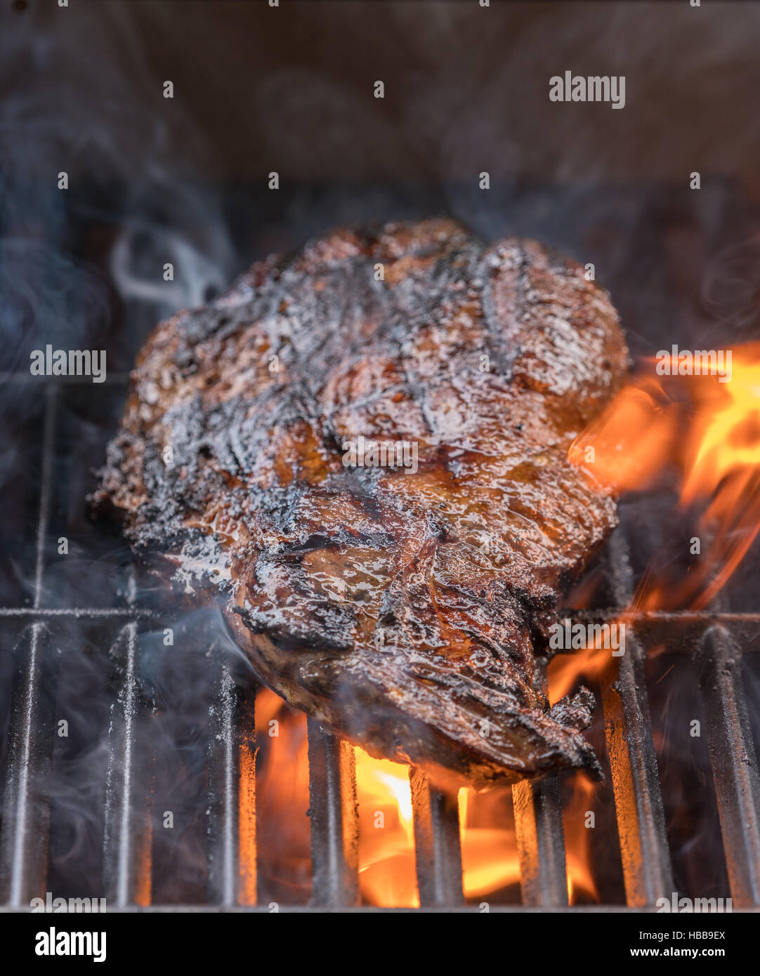 Large fillet of beef flaming on barbeque Stock Photo