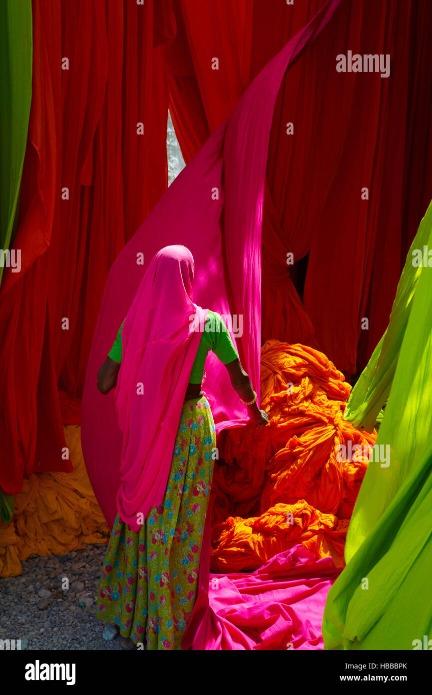 India, Rajasthan, Sari Factory, Textile are dried in the open air. Collecting of dry textile are folded by women Stock Photo