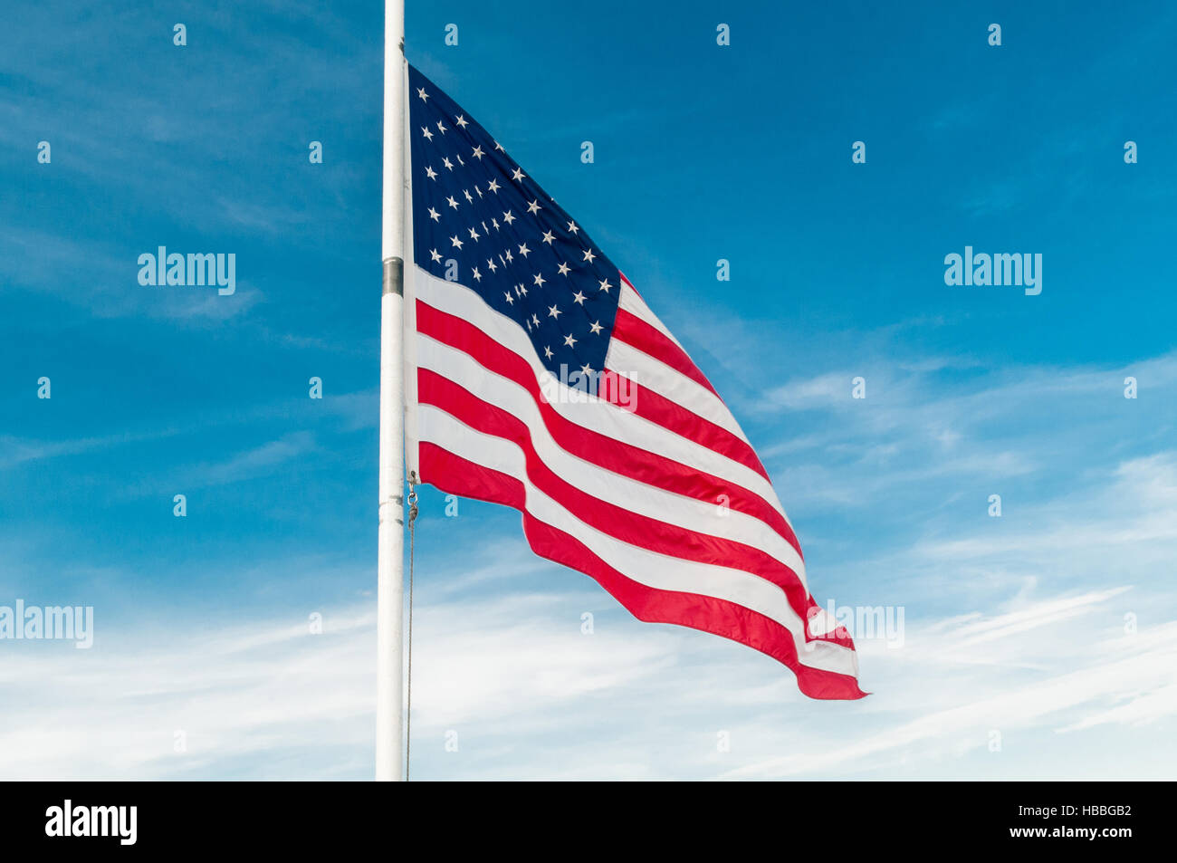 American flag against bright blue sky Stock Photo - Alamy