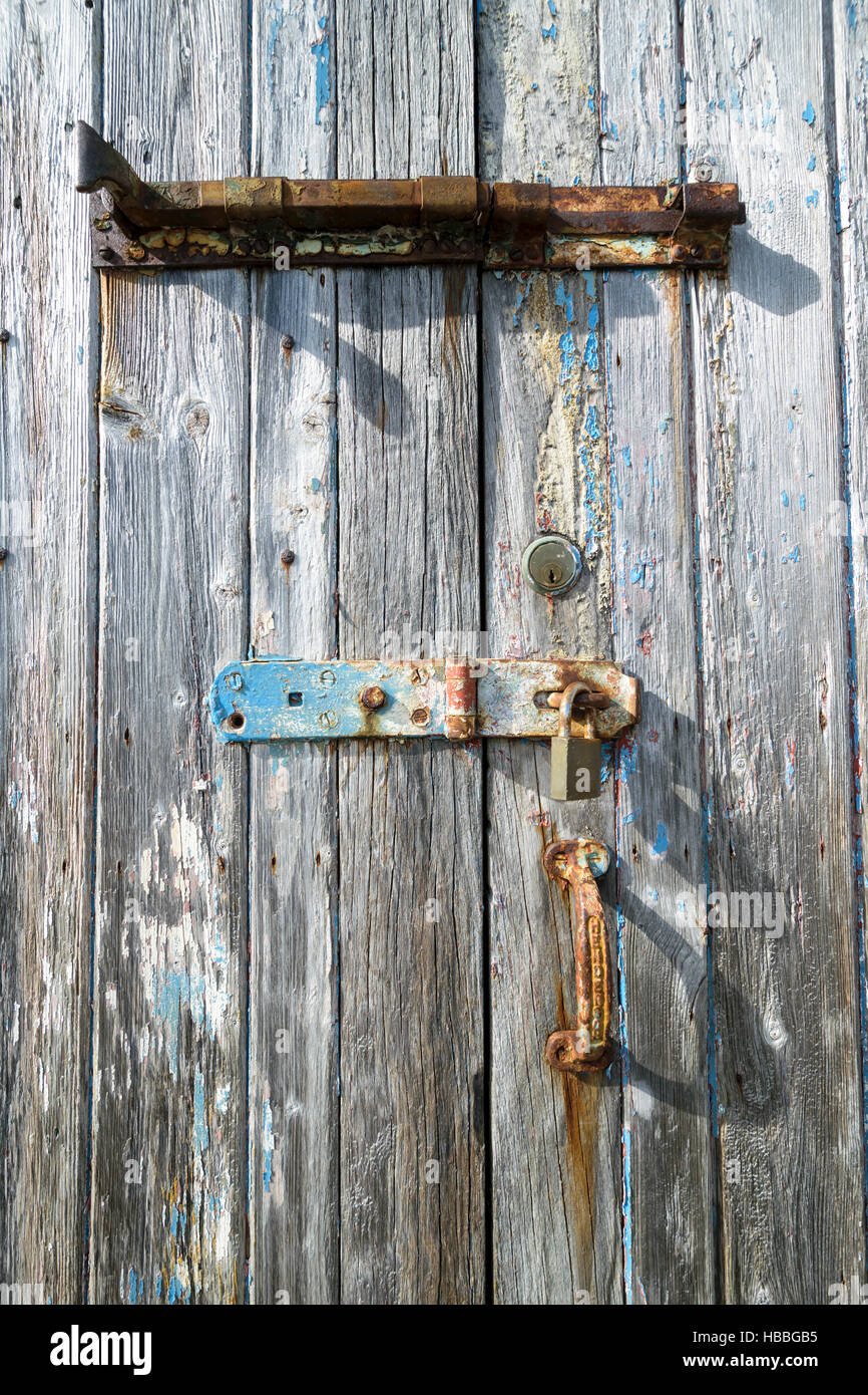 Old wooden weathered painted door with traces of rust and multiple ...