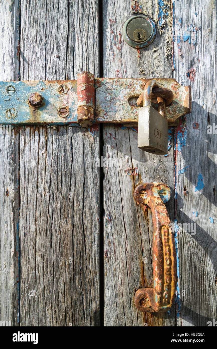 Old wooden weathered painted door with traces of rust and multiple ...