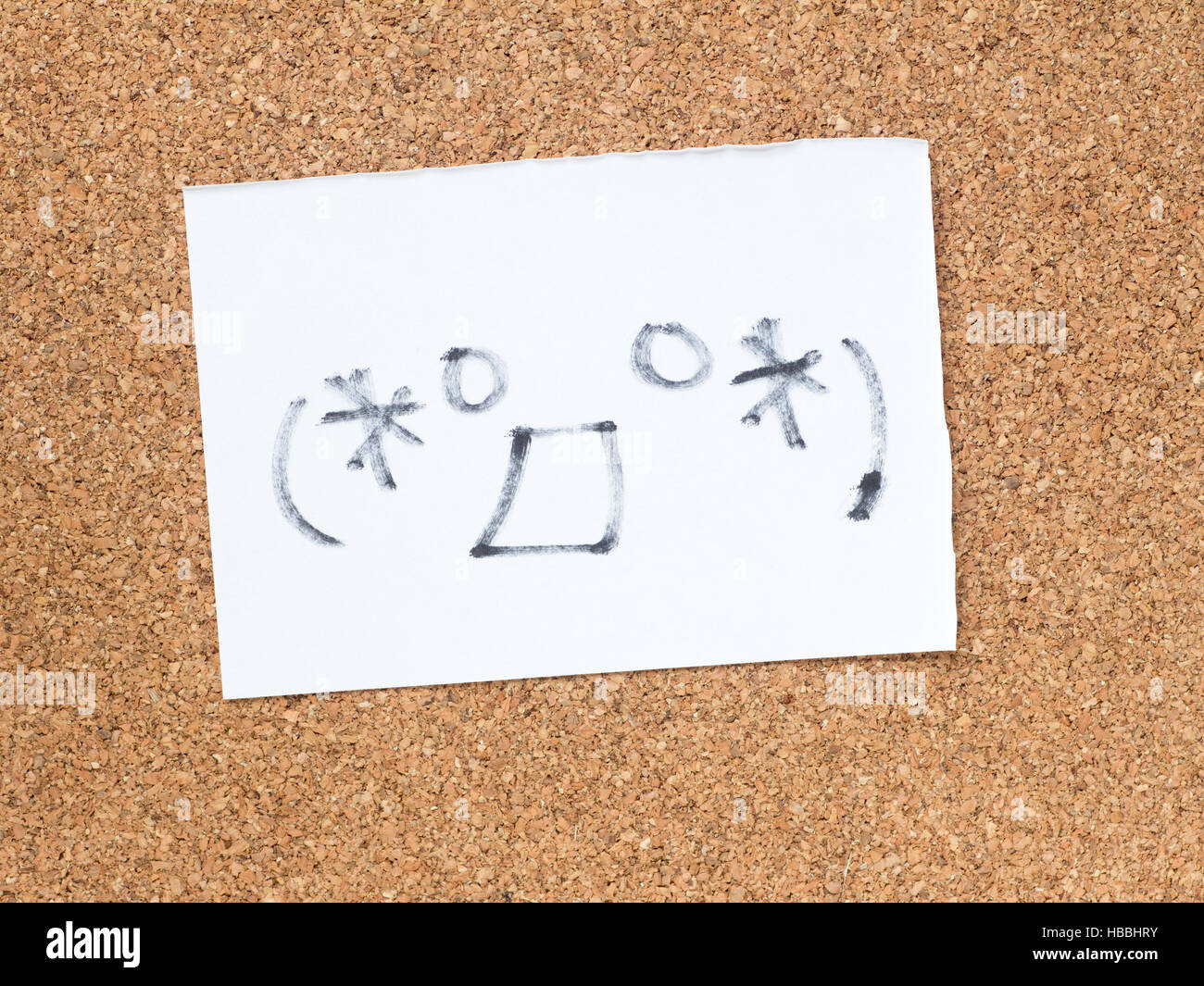The series of Japanese emoticons called Kaomoji on the cork board