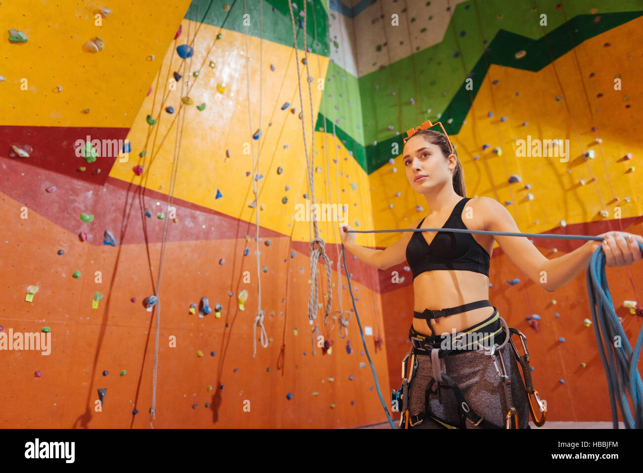 Pretty woman using climbing equipment Stock Photo Alamy