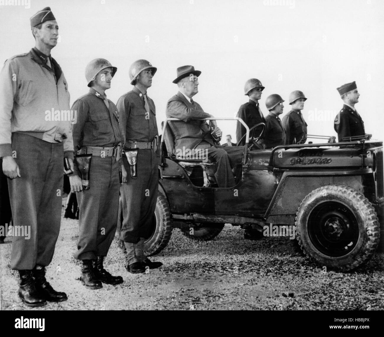 President Franklin D. Roosevelt (in car), flanked by decorated officers ...