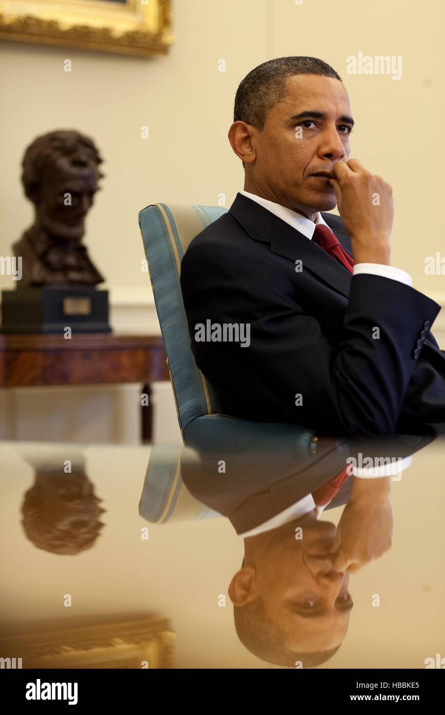 President Barack Obama listens to his senior advisors during an Oval ...