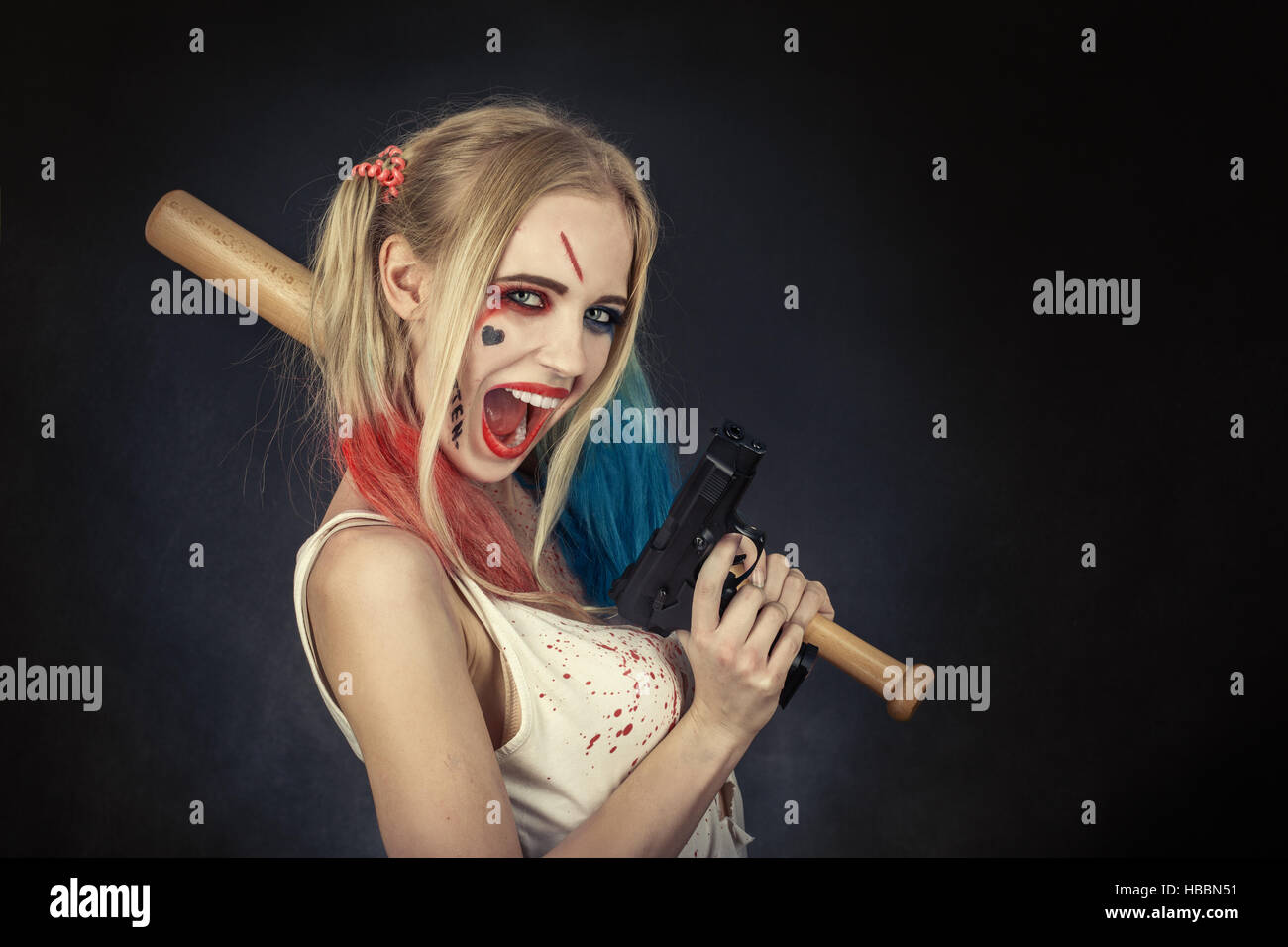 Cosplayer girl in Harley Quinn makeup and costume Stock Photo