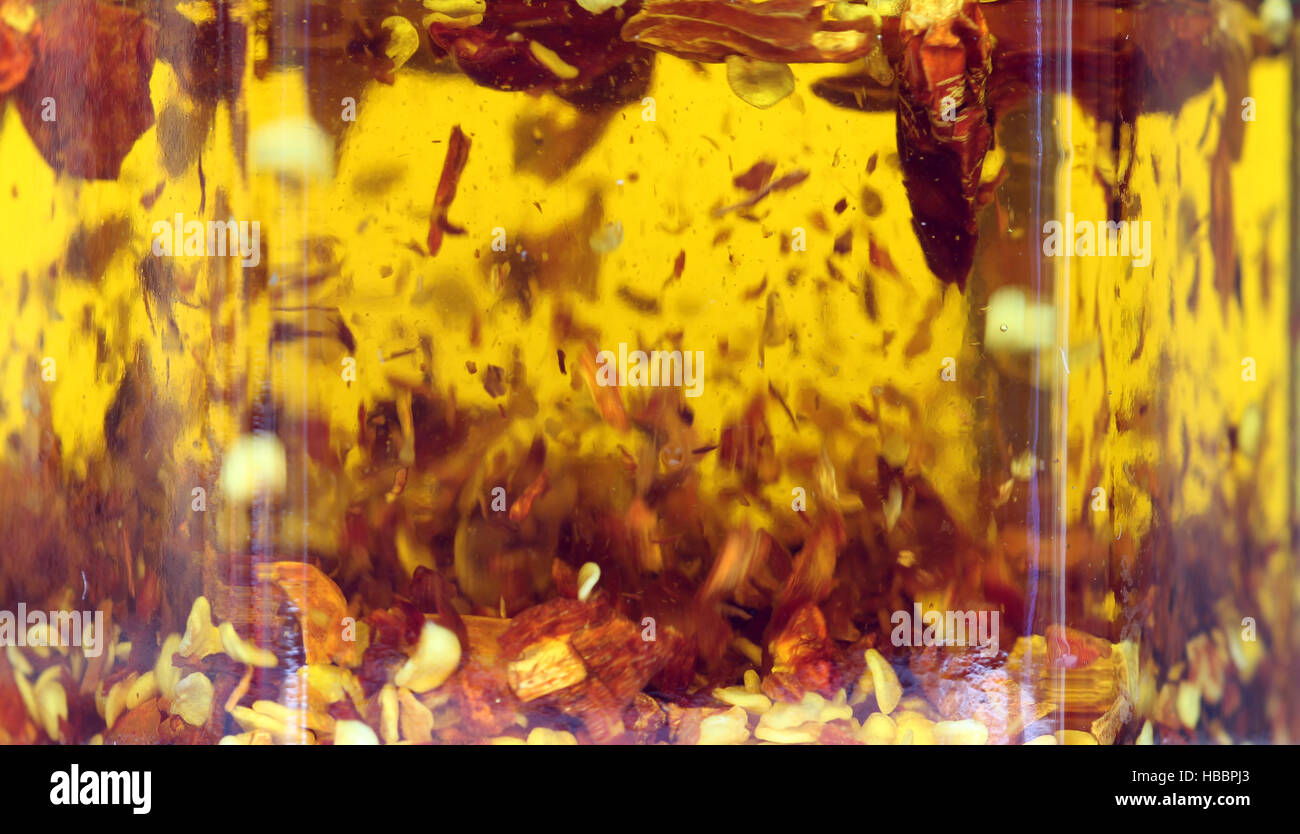 chili flakes in olive oil Stock Photo Alamy